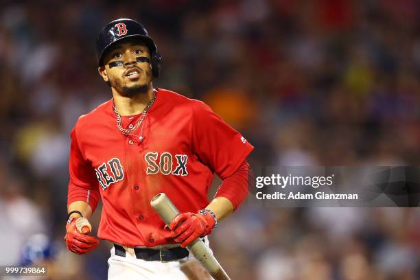 Mookie Betts of the Boston Red Sox runs to first base during a game against the Toronto Blue Jays at Fenway Park on July 13, 2018 in Boston,...