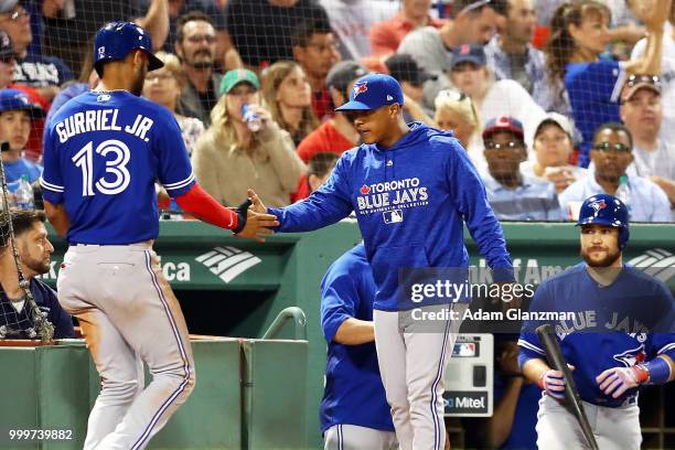 Lourdes Gurriel Jr. #13 of the Toronto Blue Jays returns to the dugout after scoring in the eighth inning of a game against the Boston Red Sox at...