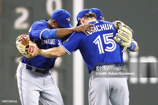 Randal Grichuk, Curtis Granderson and Kevin Pillar of the Toronto Blue Jays react after a victory over the Boston Red Sox at Fenway Park on July 13,...