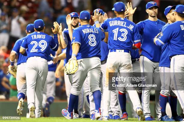 The Toronto Blue Jays high five each other after a victory over the Boston Red Sox at Fenway Park on July 13, 2018 in Boston, Massachusetts.