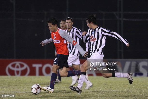 Omar Bravo of Chivas de Guadalajara fights for the ball with Victor Caceres and Roberto Gamarra of Libertad during a Libertadores Cup match at...