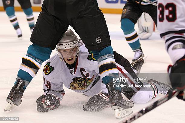 Jonathan Toews of the Chicago Blackhawks is down on the ice underneath the legs of a San Jose Sharks player in the second period of Game Two of the...