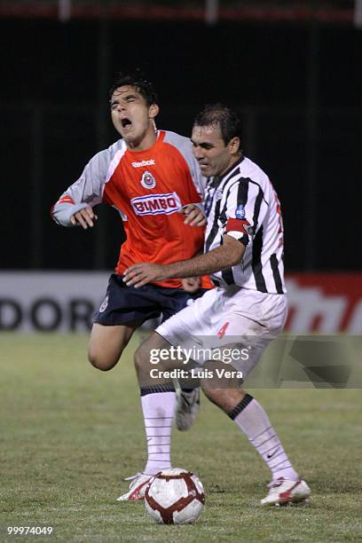 Omar Bravo of Chivas de Guadalajara fights for the ball with Pedro Sarabia of Libertad during a Libertadores Cup match at Defensores del Chaco...