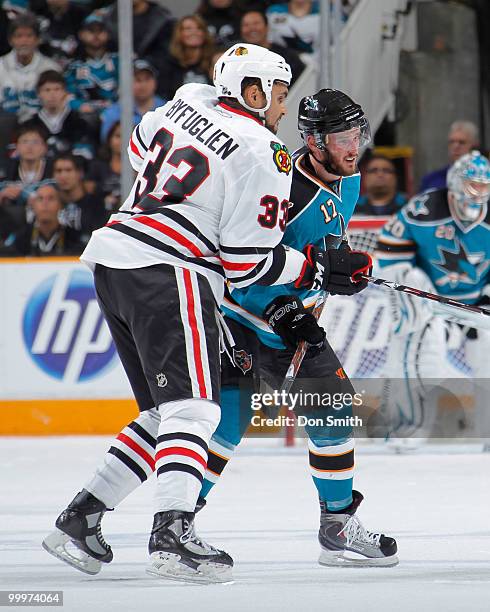 Dustin Byfuglien of the Chicago Blackhawks, battles Torrey Mitchell of the San Jose Sharks in Game Two of the Western Conference Finals during the...