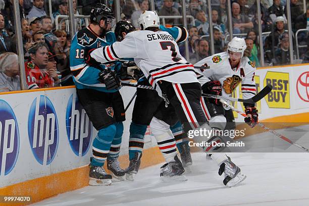 Brent Seabrook of the Chicago Blackhawks, holds Patrick Marleau of the San Jose Sharks off the puck in Game Two of the Western Conference Finals...