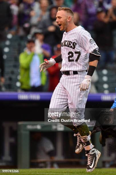 Trevor Story of the Colorado Rockies celebrates on the base paths after hitting a ninth-inning, walk-off home run against the Seattle Mariners at...