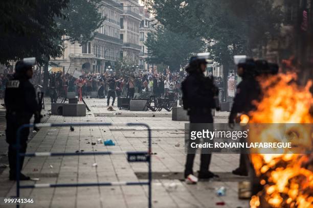 French anti riot police officers stand guard during clashes in Lyon, on July 15 after France won the Russia 2018 World Cup final football match...