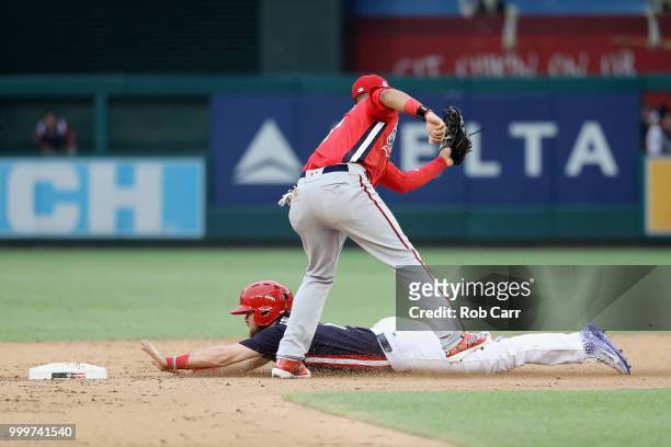 Brendan Rodgers of the Colorado Rockies and the U.S. Team beats the tag on Keibert Ruiz of the Los Angeles Dodgers and the World Team after stealing...