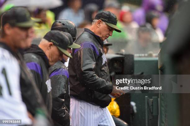 Manager Bud Black of the Colorado Rockies looks over the lineup card during a game against the Seattle Mariners at Coors Field on July 15, 2018 in...