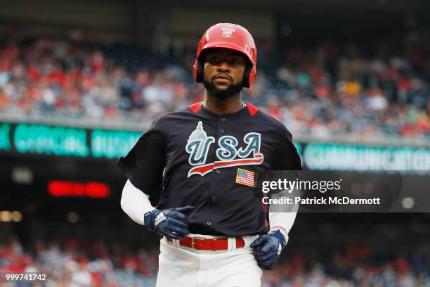 Jo Adell of the U.S. Team scores on a passed ball against the World Team in the seventh inning during the SiriusXM All-Star Futures Game at Nationals...