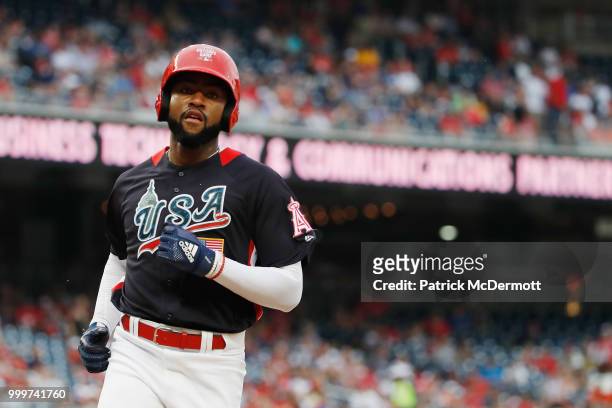 Jo Adell of the U.S. Team scores on a passed ball against the World Team in the seventh inning during the SiriusXM All-Star Futures Game at Nationals...