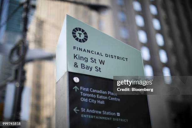 Sign for the financial district stands in Toronto, Ontario, Canada, on Wednesday, July 11, 2018. Canadian stocks were mixed Friday as health care...