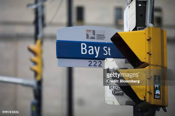 Sign for Bay Street hangs in the financial district of Toronto, Ontario, Canada, on Wednesday, July 11, 2018. Canadian stocks were mixed Friday as...