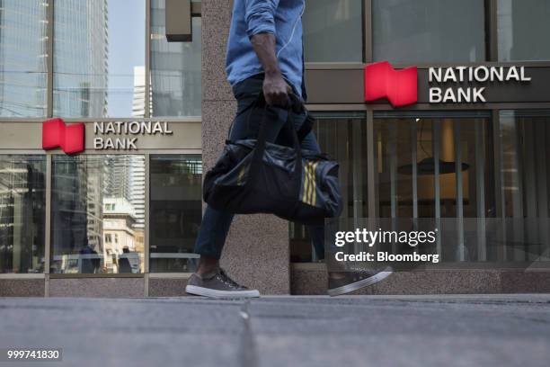 Pedestrian walks past a National Bank of Canada branch in the financial district of Toronto, Ontario, Canada, on Wednesday, July 11, 2018. Canadian...