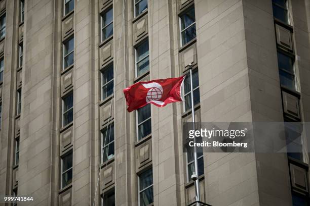 Bank of Nova Scotia flag flies outside the company's building in the financial district of Toronto, Ontario, Canada, on Wednesday, July 11, 2018....