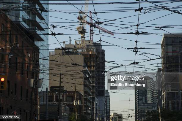 Power lines run in front of a building under construction in Toronto, Ontario, Canada, on Wednesday, July 11, 2018. Canadian stocks were mixed Friday...