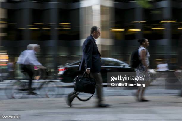 Pedestrians walk in the financial district of Toronto, Ontario, Canada, on Wednesday, July 11, 2018. Canadian stocks were mixed Friday as health care...
