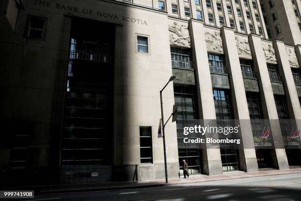 Pedestrian walks past a Bank of Nova Scotia building in the financial district of Toronto, Ontario, Canada, on Wednesday, July 11, 2018. Canadian...