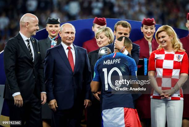 French President Emmanuel Macron , Croatian President Kolinda Grabar Kitarovic , Russian President Vladimir Putin and FIFA President Gianni Infantino...