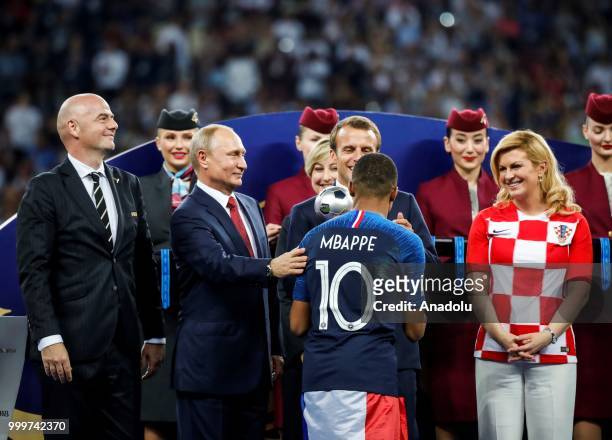 French President Emmanuel Macron , Croatian President Kolinda Grabar Kitarovic , Russian President Vladimir Putin and FIFA President Gianni Infantino...