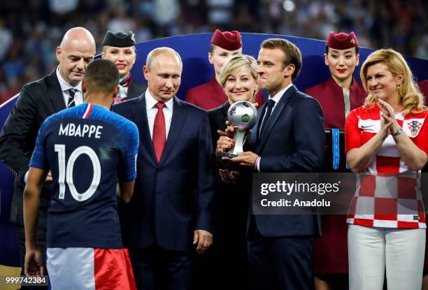 French President Emmanuel Macron , Croatian President Kolinda Grabar Kitarovic , Russian President Vladimir Putin and FIFA President Gianni Infantino...