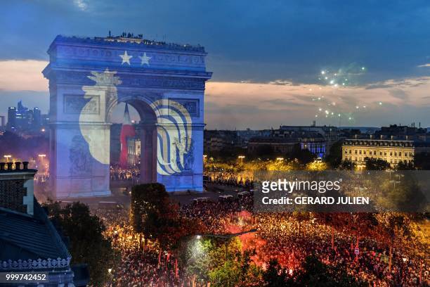 This picture taken from the terrace of the Publicis drugstore on July 15, 2018 shows a projection of the French national football team logo with two...
