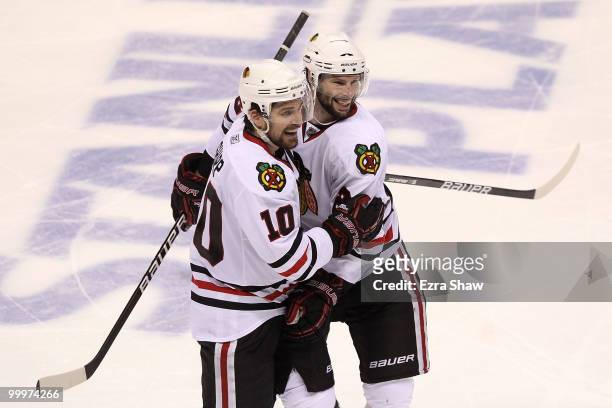 Patrick Sharp and Troy Brouwer of the Chicago Blackhawks celebrate a third period goal by Brouwer while taking on the San Jose Sharks in Game Two of...
