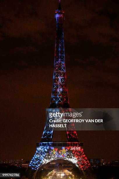 This picture taken from Trocadero on July 15, 2018 shows the Eiffel Tower illuminated in French national colors during celebrations after the Russia...