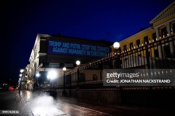 Sentence reading Trump and Putin: stop the crimes against humanity in Chechnya is projected on the presidential palace on the eve of a summit between...