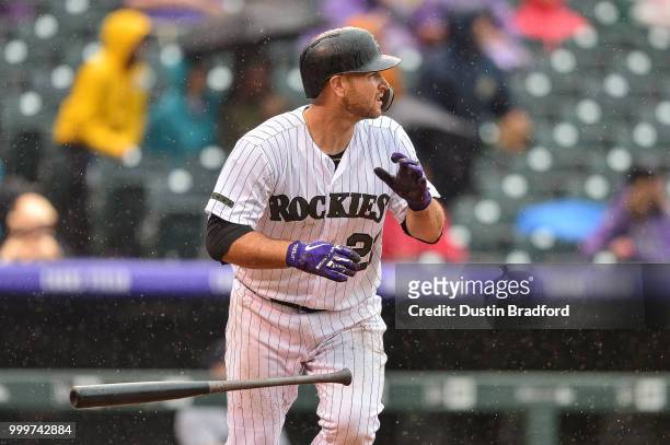 Chris Iannetta of the Colorado Rockies hits a game-tying RBI sacrifice fly against the Seattle Mariners in the seventh inning of a game at Coors...