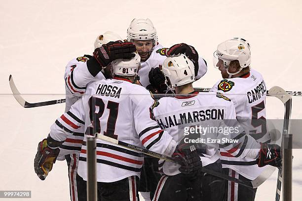 Troy Brouwer of the Chicago Blackhawks celebrates his third period goal with teammates Marian Hossa, Patrick Sharp, Brian Campbell and Niklas...