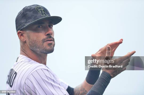 Ian Desmond of the Colorado Rockies claps as members of the armed forces are recognized on Military Appreciation Day during a game against the...