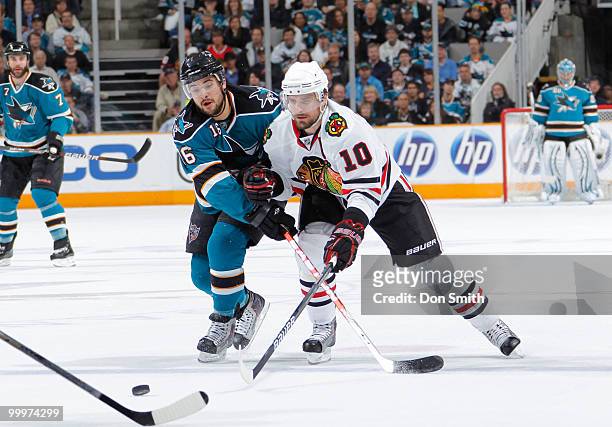 Patrick Sharp of the Chicago Blackhawks battles Devin Setoguchi of the San Jose Sharks for the puck in Game Two of the Western Conference Finals...