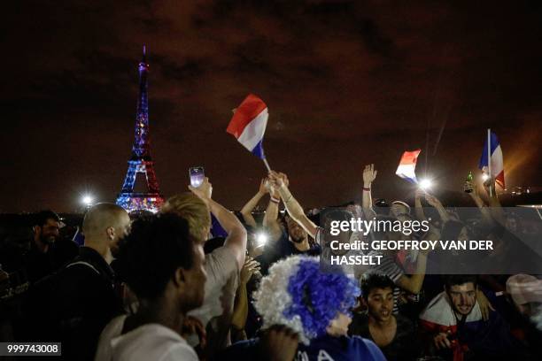 This picture taken from Trocadero on July 15, 2018 shows the Eiffel Tower illuminated in French national colors during celebrations after the Russia...