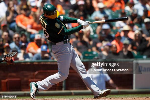 Stephen Piscotty of the Oakland Athletics hits an RBI single against the San Francisco Giants during the fourth inning at AT&T Park on July 15, 2018...