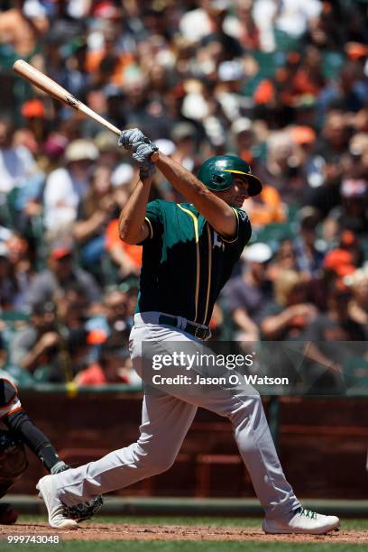 Matt Olson of the Oakland Athletics hits an RBI single against the San Francisco Giants during the fourth inning at AT&T Park on July 15, 2018 in San...