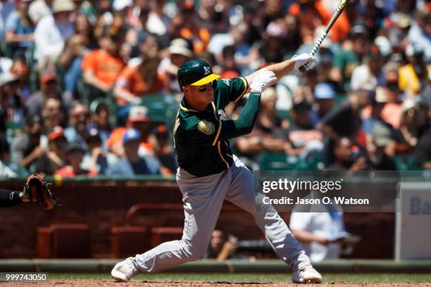 Matt Chapman of the Oakland Athletics hits an RBI single against the San Francisco Giants during the fourth inning at AT&T Park on July 15, 2018 in...