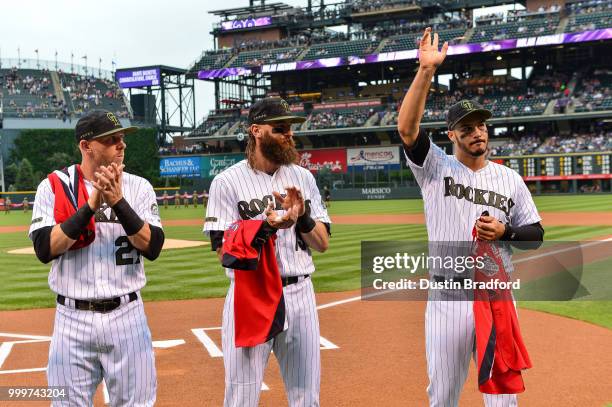 All-Star team representatives of the Colorado Rockies Trevor Story, Charlie Blackmon and Nolan Arenado stand with their jerseys before a game against...