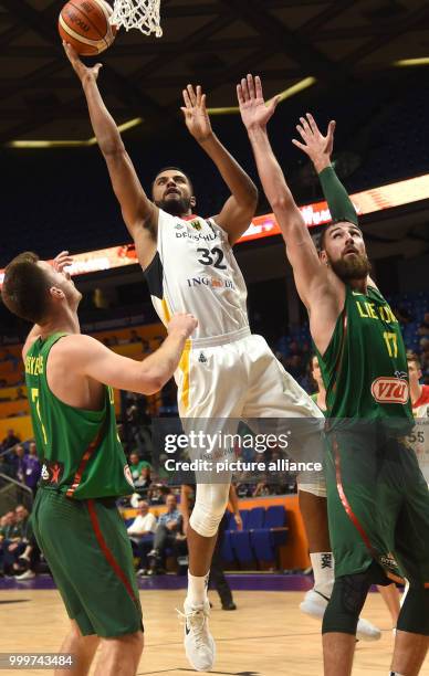 Johannes Thiemann of Germany in action between Adas Juskevicius and Jonas Valanciunas of Lithuania during the EuroBasket 2017 Group B game between...