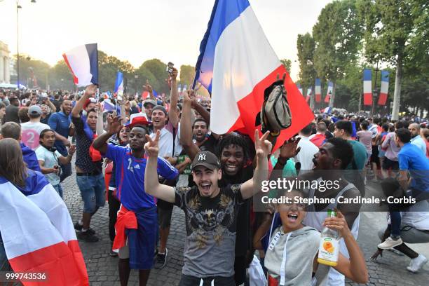 Fans celebrate the Victory of France in the World Cup 2018, on the Champs Elysees on July 15, 2018 in Paris, France.