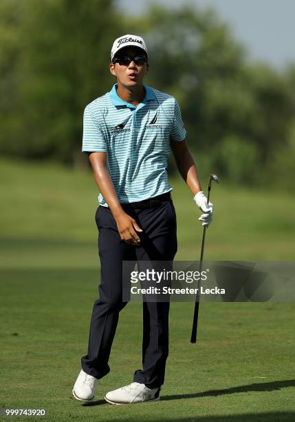 Michael Kim watches a shot on the 18th hole during the final round of the John Deere Classic at TPC Deere Run on July 15, 2018 in Silvis, Illinois.