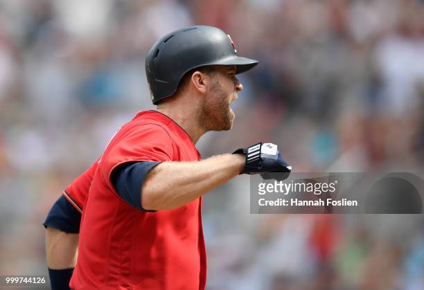Brian Dozier of the Minnesota Twins celebrates scoring a run on a balk by Diego Castillo of the Tampa Bay Rays during the seventh inning of the game...