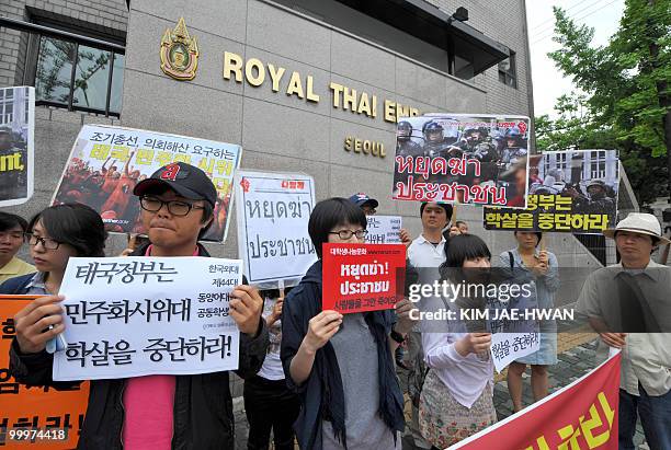 South Korean rights activists hold pickets in front of the Thai embassy in Seoul on May 19 demanding the Thai government should stop crackdowns on...