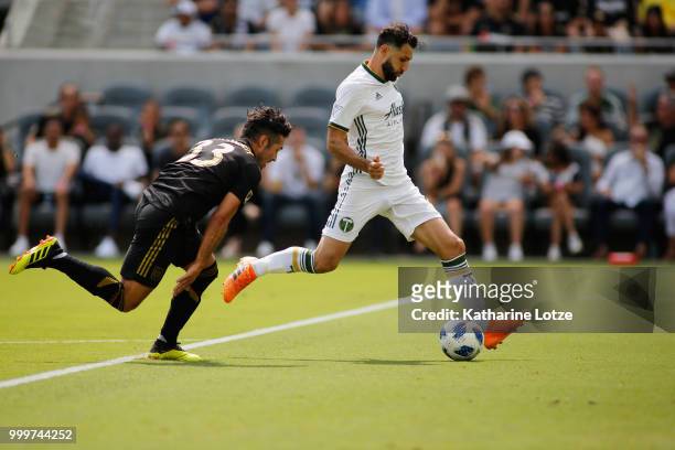 Benny Feilhaber of the Los Angeles Football Club and Diego Valeri of the Portland Timbers fight for control of the ball at Banc of California Stadium...