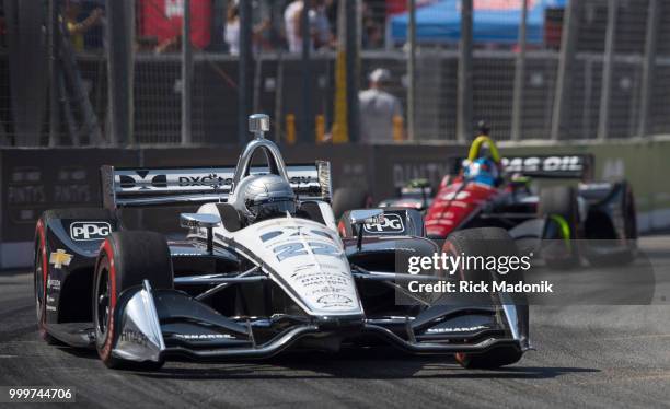 Simon Pagenaud works his way through the back of the course. Scott Dixon, of New Zealand, takes the checkered flag at Honda Indy Toronto race at CNE...