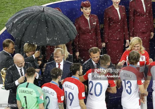 Croatian players shake hands with Russian President Vladimir Putin, Croatian President Kolinda Grabar Kitarovic, French President Emmanuel Macron and...