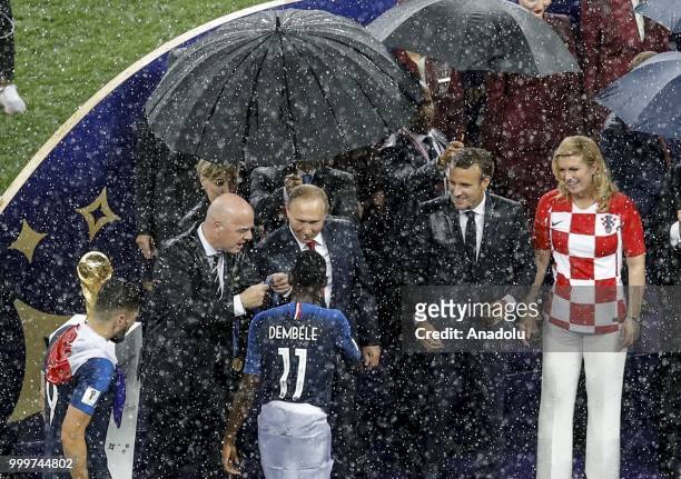 Croatian players shake hands with Russian President Vladimir Putin, Croatian President Kolinda Grabar Kitarovic, French President Emmanuel Macron and...