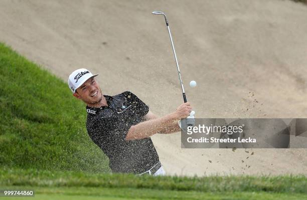 Bronson Burgoon hits a shot from the sand on the 18th hole during the final round of the John Deere Classic at TPC Deere Run on July 15, 2018 in...