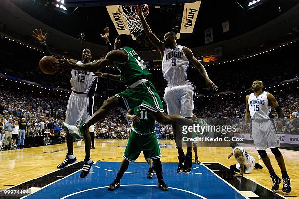Tony Allen of the Boston Celtics passes the ball as he is defended by Dwight Howard, Rashard Lewis and Vince Carter of the Orlando Magic in Game Two...
