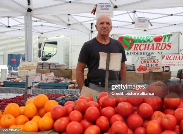 Farmer Ron Samascott with his stall at the Greenmarket in Oculus Plaza, a farmers' market at the base of the new World Trade Center in New York, USA,...
